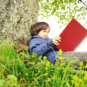 Happy Children Reading The Book Under The Tree Sbi 300996367 (1)
