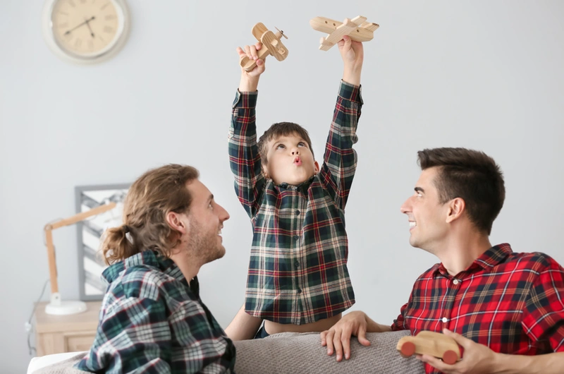 Two Men On Sofa With Child Webp