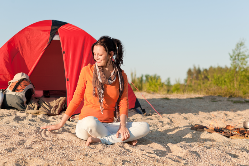 Camping Happy Woman Sitting By Campfire Relaxing On Beach SBI 300902245